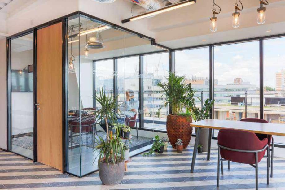 Example of a Studio Alliance office design solution featuring a small office space made predominantly of glass, and with a city view